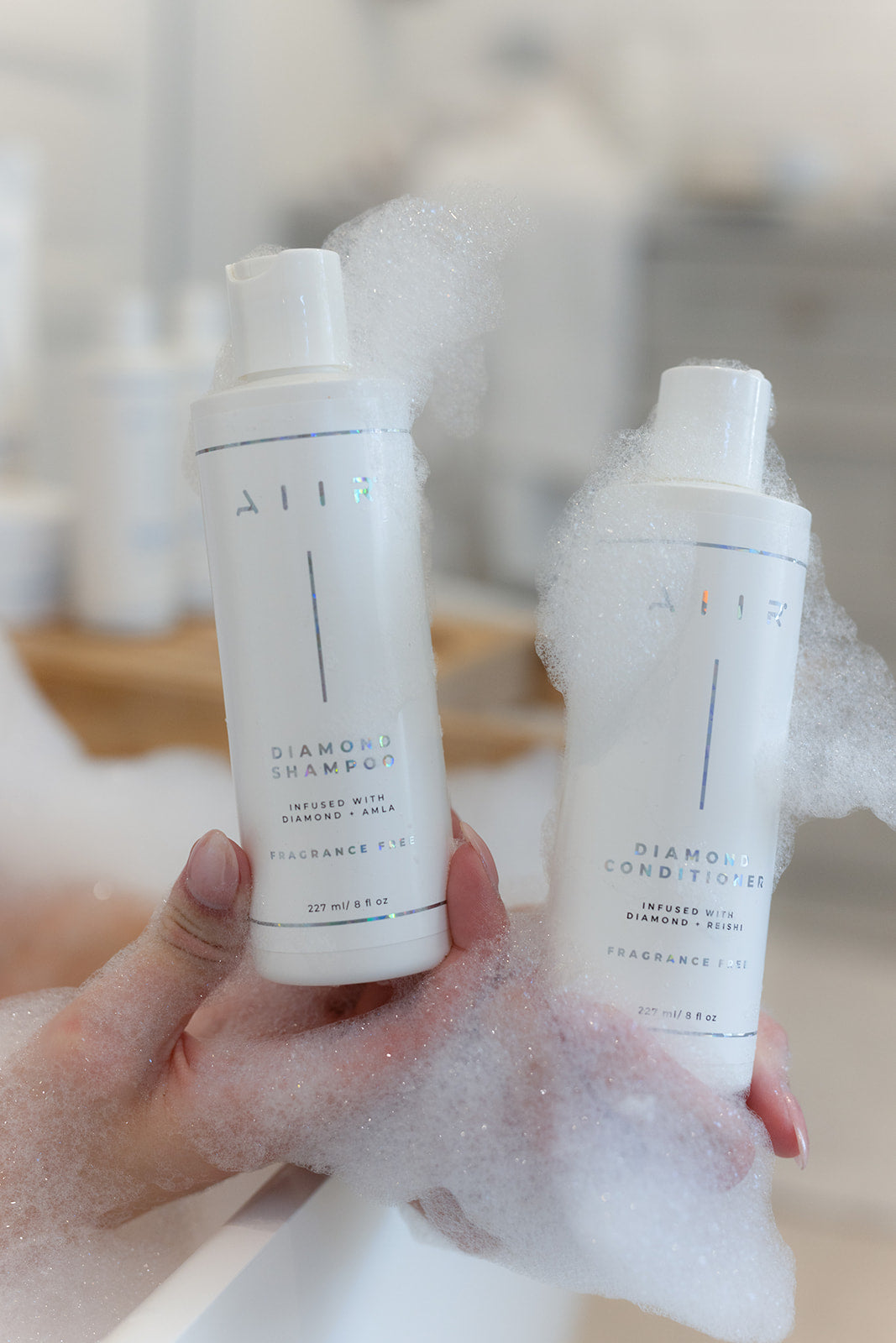 AIIR Diamond Shampoo and Conditioner fragrance-free duo in bath bubbles